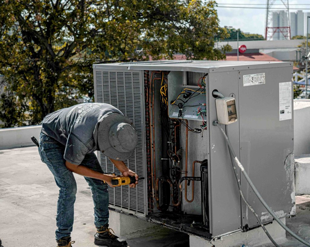 technician repairing HVAC system